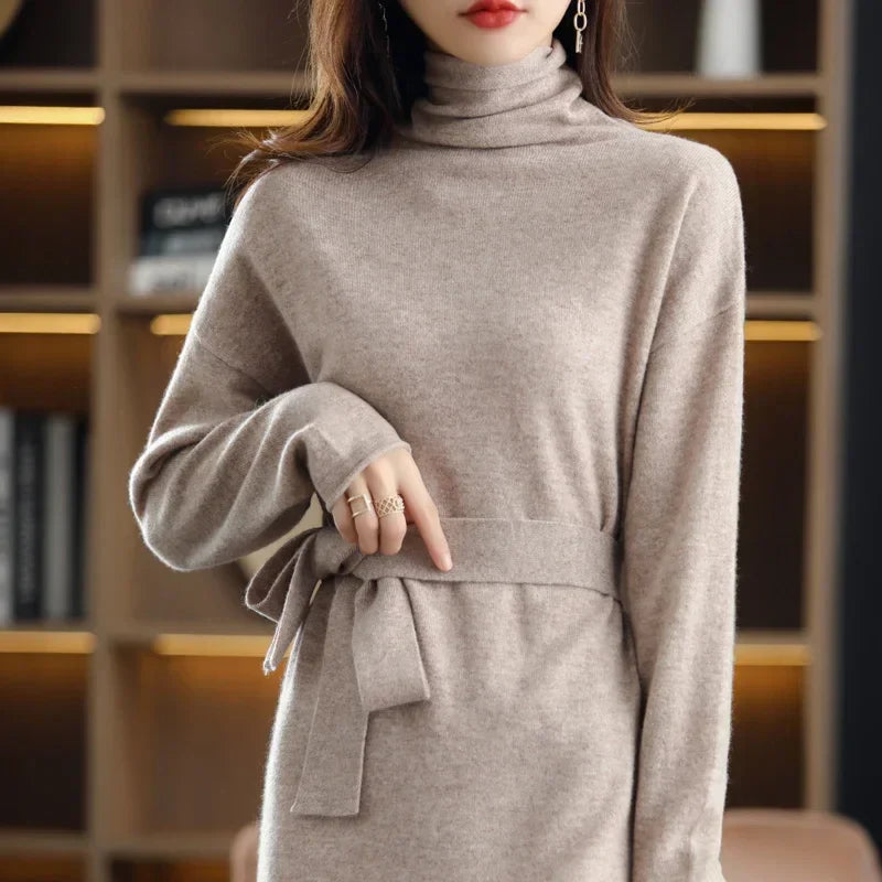 Beige wool midi sweater dress with a high-neck, long sleeves, and a waist-defining tie in a soft knit texture.