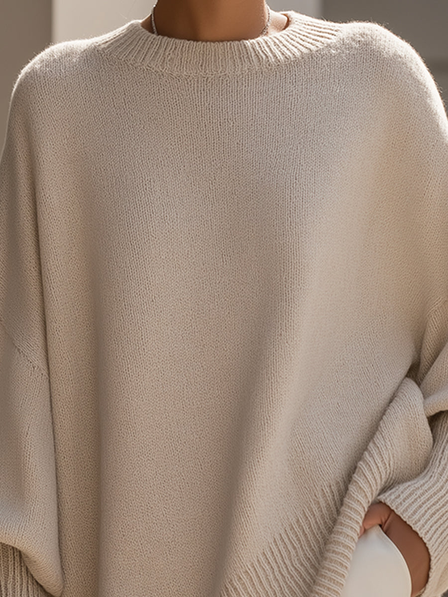 Beige oversized ribbed knit sweater with a relaxed, loose-fit silhouette and structured crew neckline.