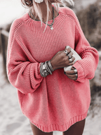 Oversized pink chunky knit sweater with balloon sleeves, dropped shoulders, and a ribbed crewneck.