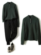 Dark green cable-knit wool blend sweater featuring a button-up stand collar, paired with black trousers and sneakers.