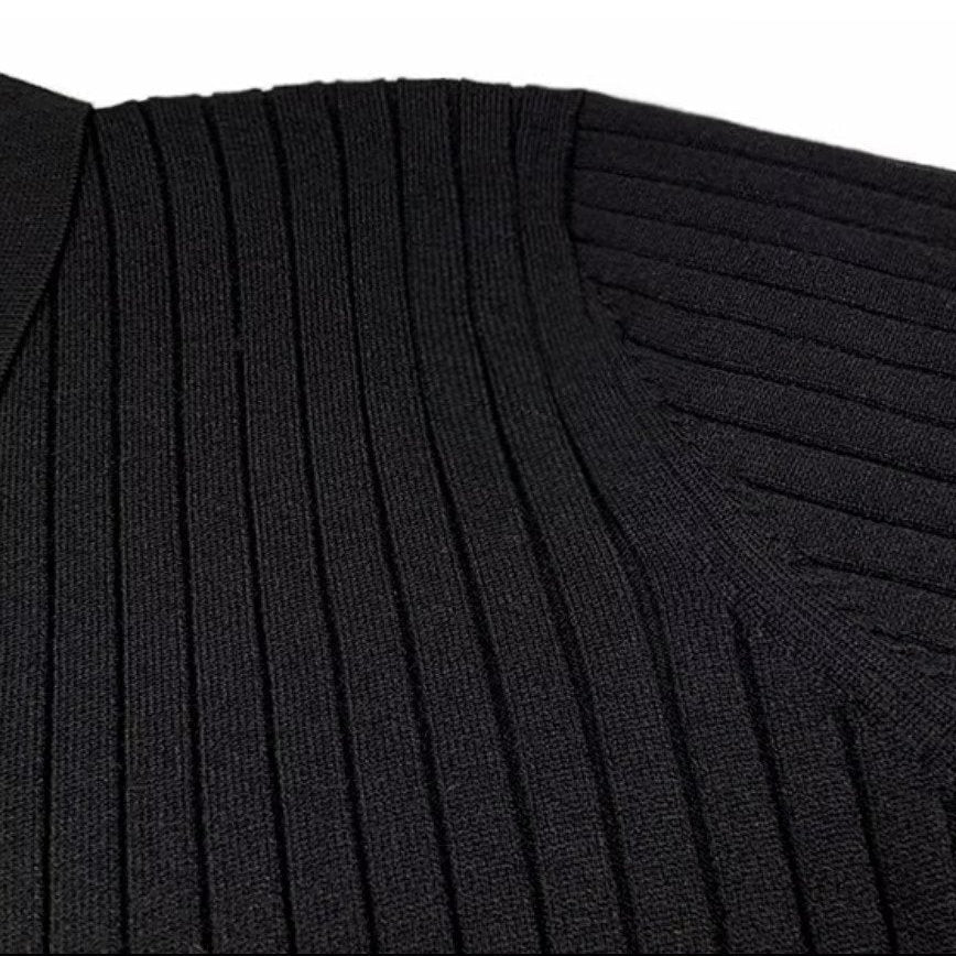 Black long-sleeve polo sweater in a structured vertical rib-knit texture with a refined lapel collar.