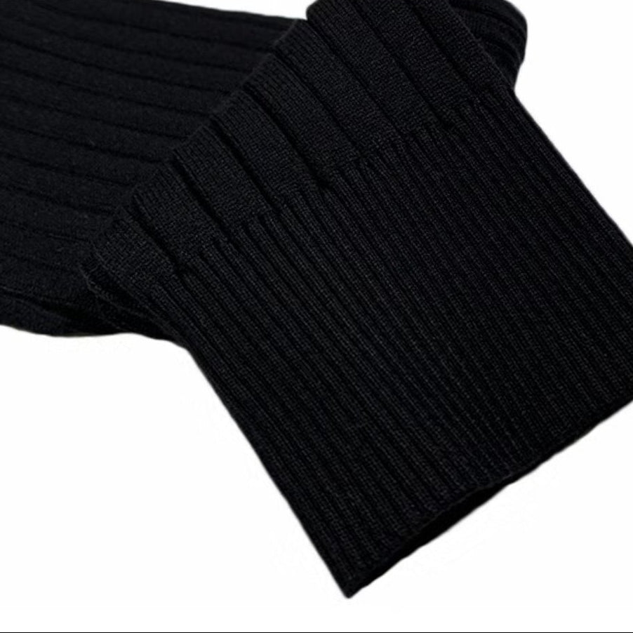 Black long-sleeve polo sweater featuring a vertical rib-knit texture and a structured, ribbed cuff.