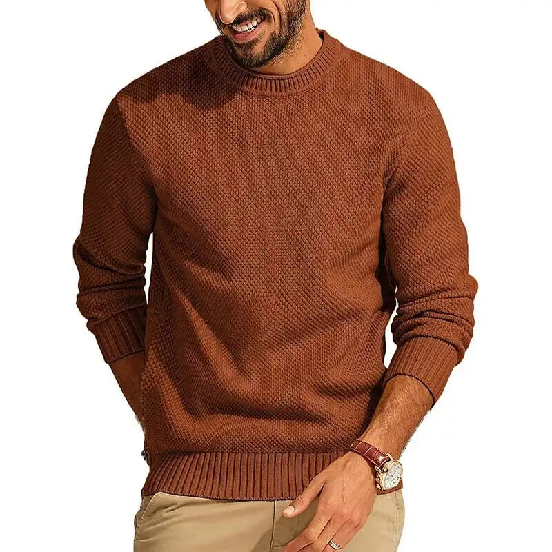 Rust-colored crew neck sweater in a waffle-knit texture with a relaxed fit, ribbed cuffs, and a structured hem.