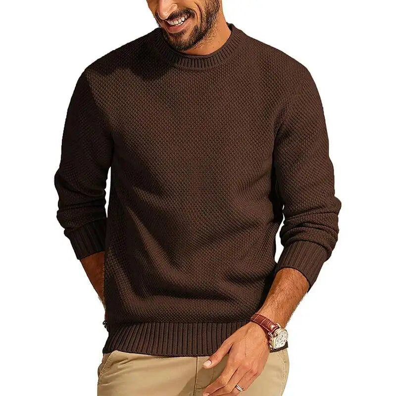 Rust-colored waffle knit crew neck sweater with a relaxed fit, ribbed cuffs, and hem worn by a man.