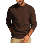 Rust-colored waffle knit crew neck sweater with a relaxed fit, ribbed cuffs, and hem worn by a man.