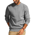 Grey waffle-knit crew neck sweater with a relaxed fit, long sleeves, and ribbed cuffs and hem.