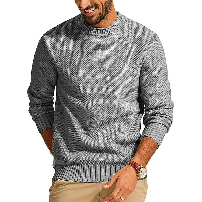 Grey waffle-knit crew neck sweater with a relaxed fit, long sleeves, and ribbed cuffs and hem.