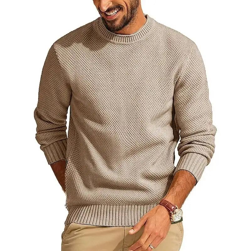 Tan waffle-knit crew neck sweater with a relaxed fit, ribbed cuffs, and hem, worn by a man in a casual setting.