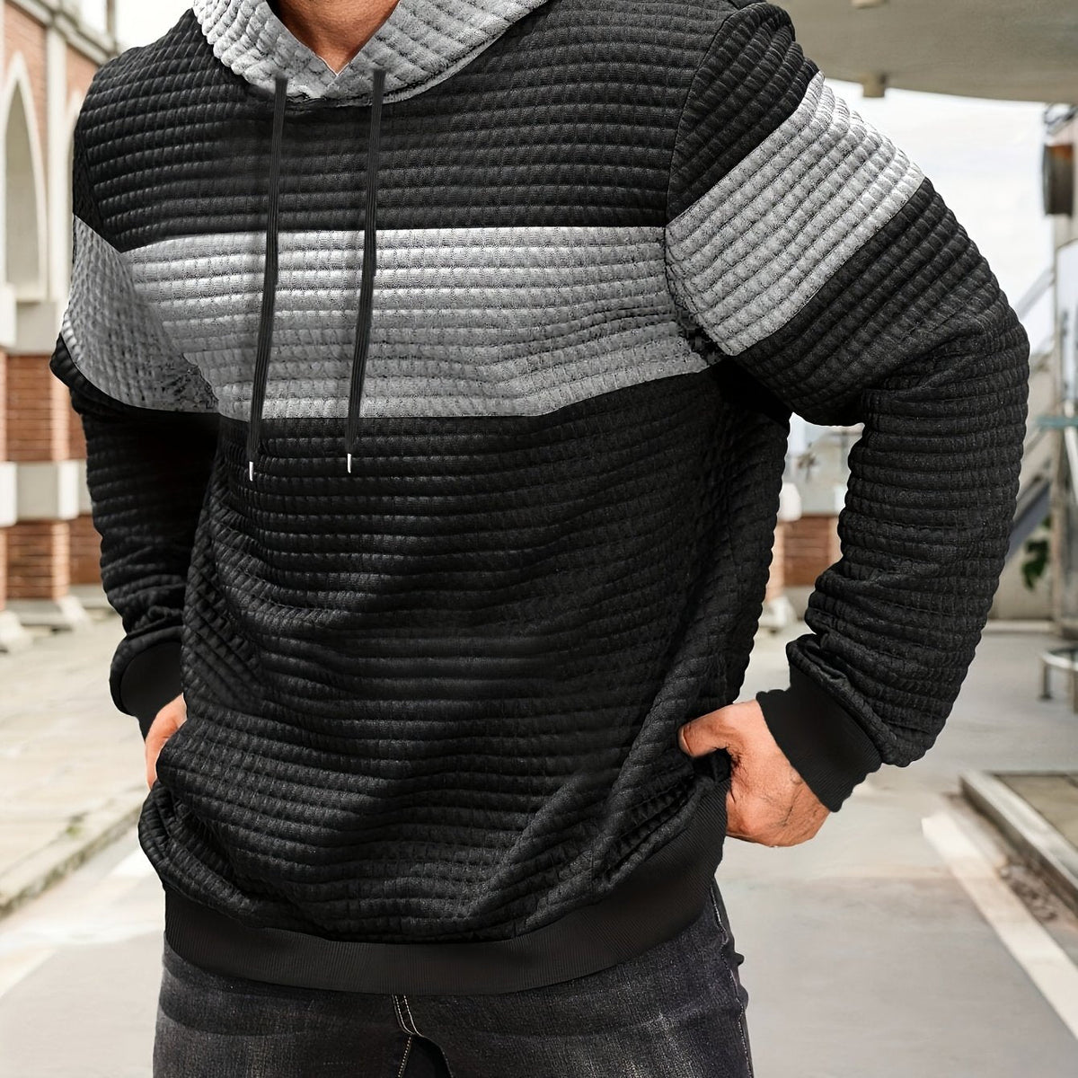Colorblock Waffle-Knit Hoodie – Black and light gray colorblock waffle-knit hoodie worn by a male mode