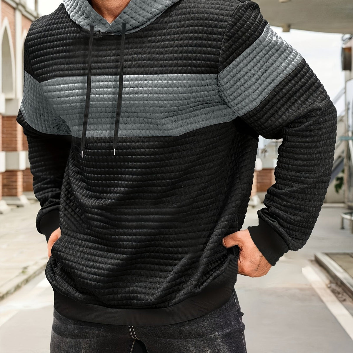 Colorblock Waffle-Knit Hoodie – Black and silver gray colorblock waffle-knit hoodie worn by a male model