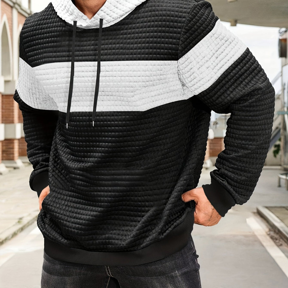 Colorblock Waffle-Knit Hoodie – Black and white colorblock waffle-knit hoodie worn by a male model