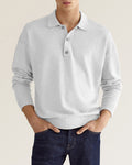 Light grey long-sleeve knit polo with a relaxed dropped-shoulder fit, ribbed collar, and two-button placket.