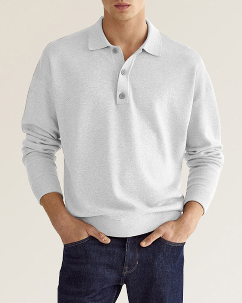 Light grey long-sleeve knit polo with a relaxed dropped-shoulder fit, ribbed collar, and two-button placket.