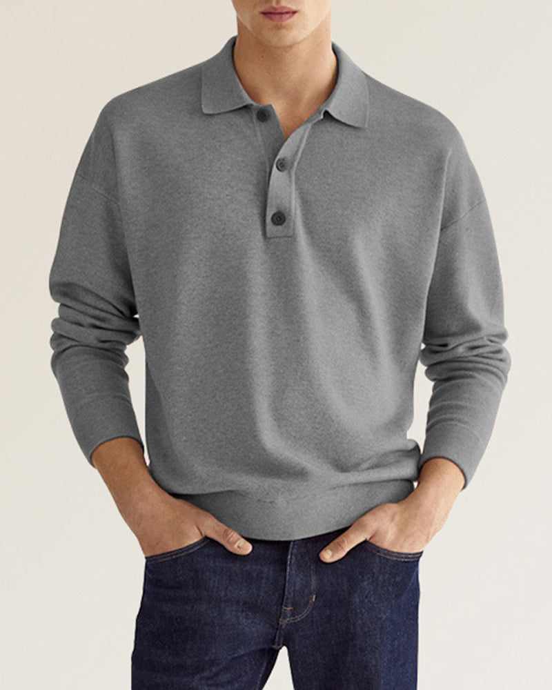Grey long-sleeve knit polo with a relaxed dropped-shoulder fit, ribbed collar, and two-button placket.