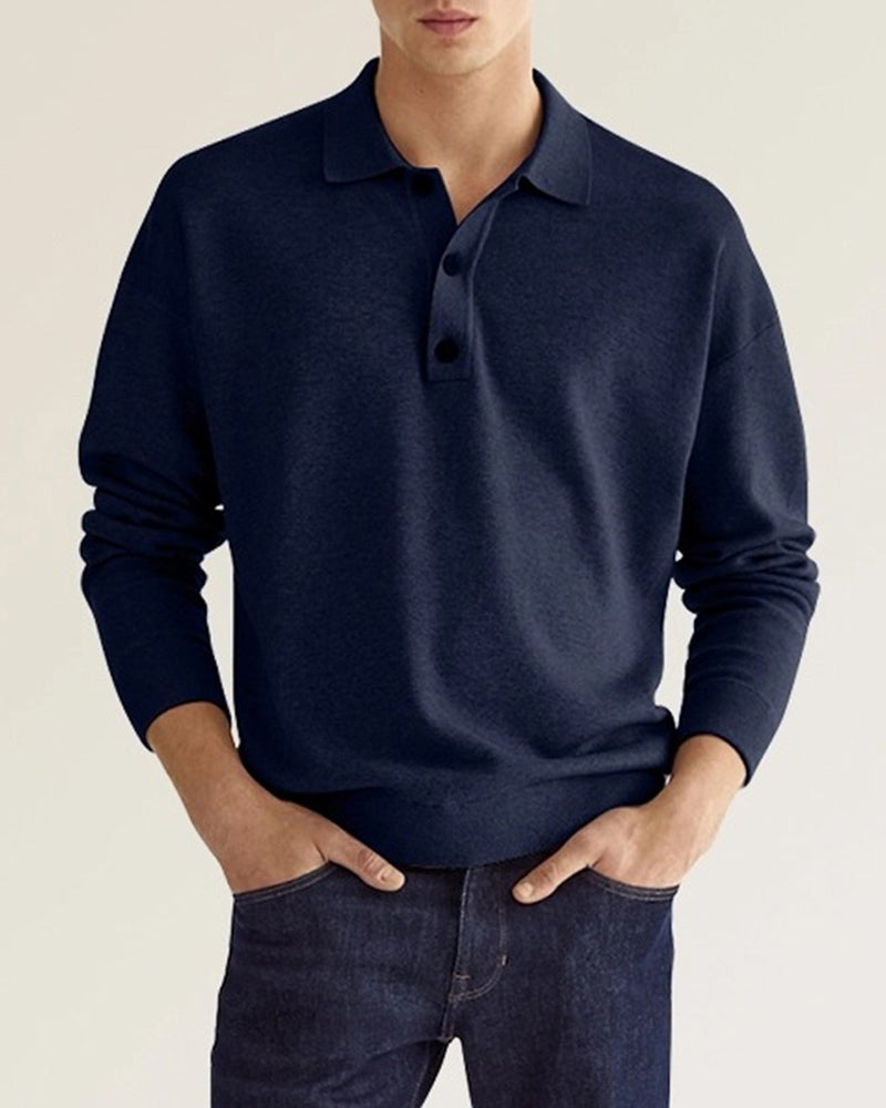 Navy blue long-sleeve knit polo with a relaxed, dropped-shoulder fit, ribbed collar, and two-button placket.