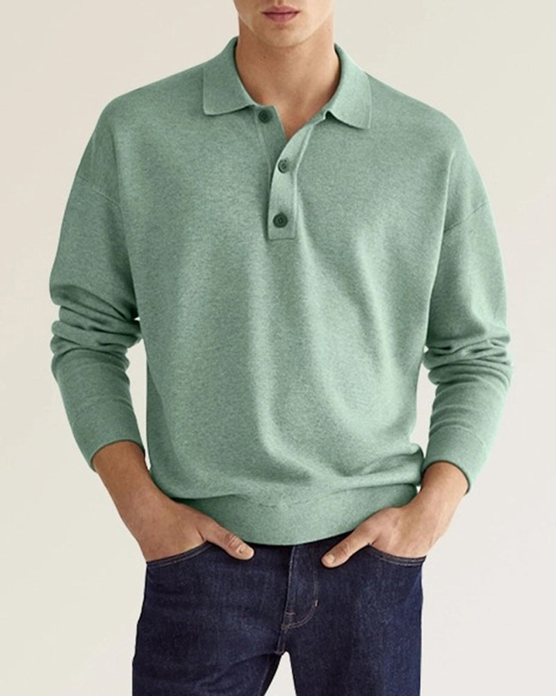 Sage green long-sleeve knit polo with a relaxed dropped-shoulder fit, ribbed collar, and two-button placket.